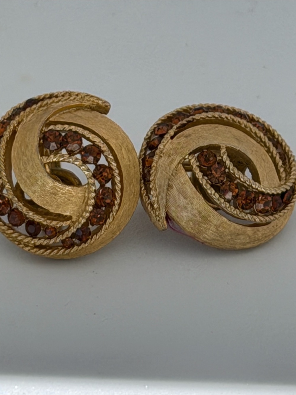 Trifari Gold-Tone Swirl Clip Earrings with Brown Crystal Detailing